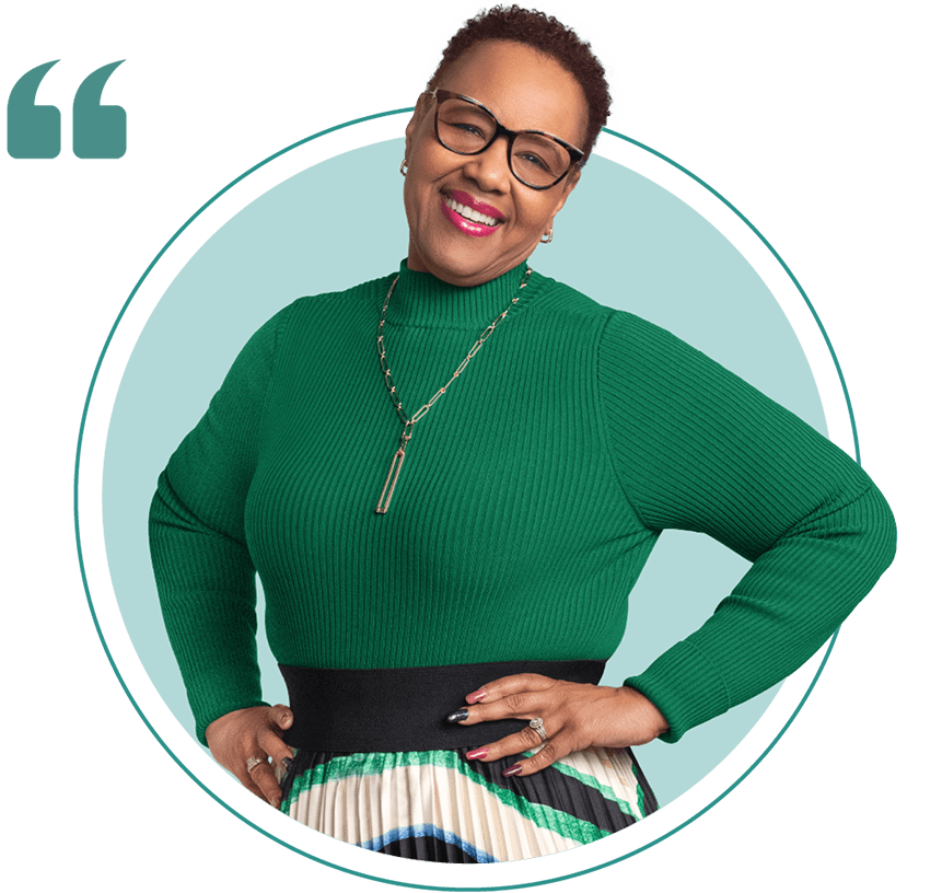 Reneé smiling with her hands on her hips